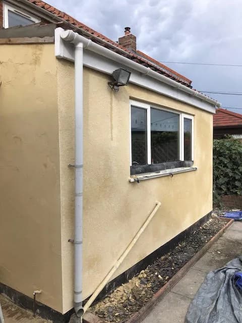 Freshly rendered extension with new guttering